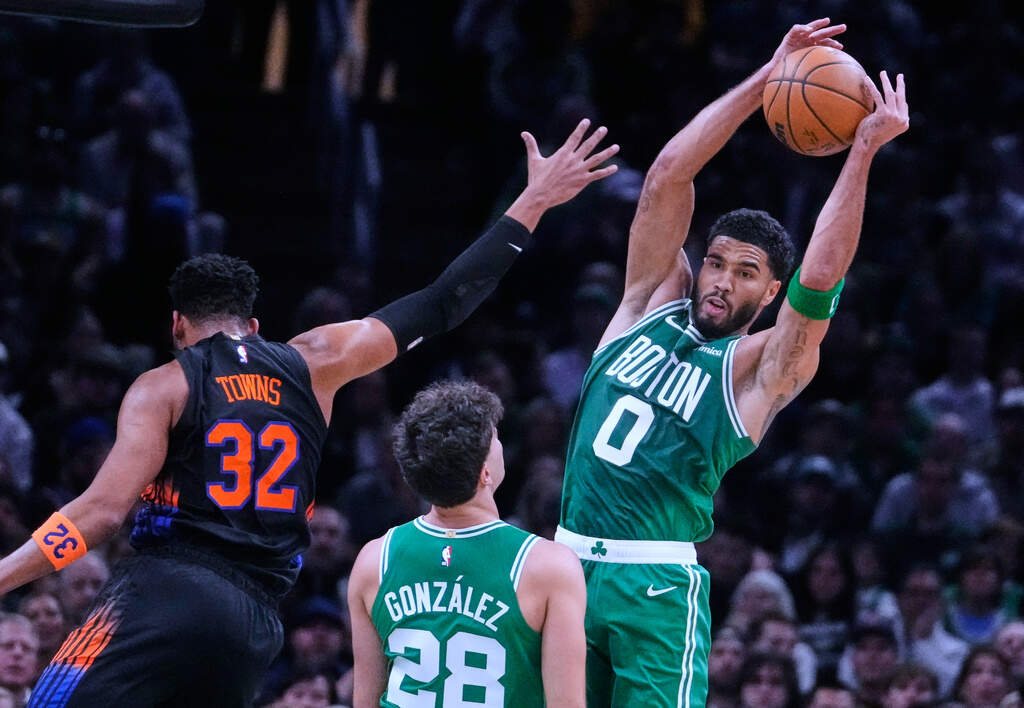 Jayson Tatum grabs a rebound over Karl-Anthony Towns of the Knicks at TD Garden.