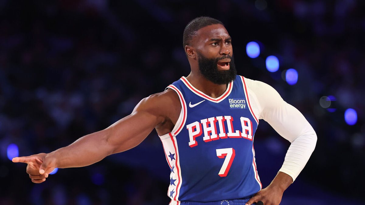 Jaylen Brown, in a blue 76ers uniform, points during a game.