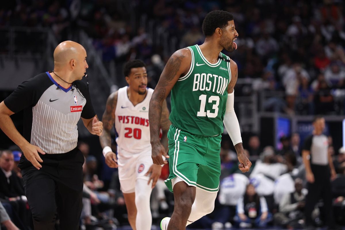 Paul George jogs back up the floor in a green Celtics uniform during the season opener against the Pistons.